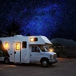 rv camping van with lights on at night